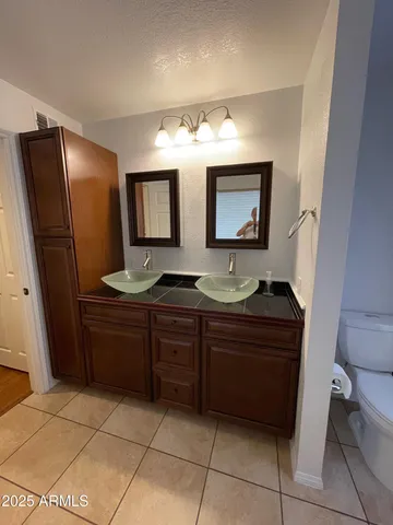 a bathroom with a sink a vanity and a mirror