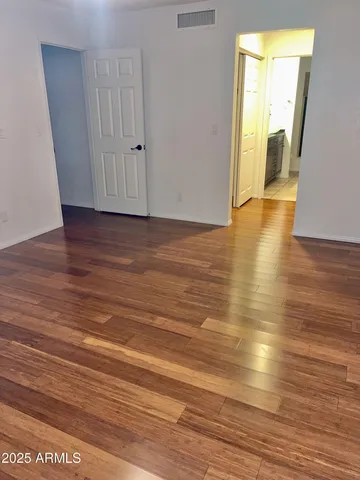 a view of a room with wooden floor