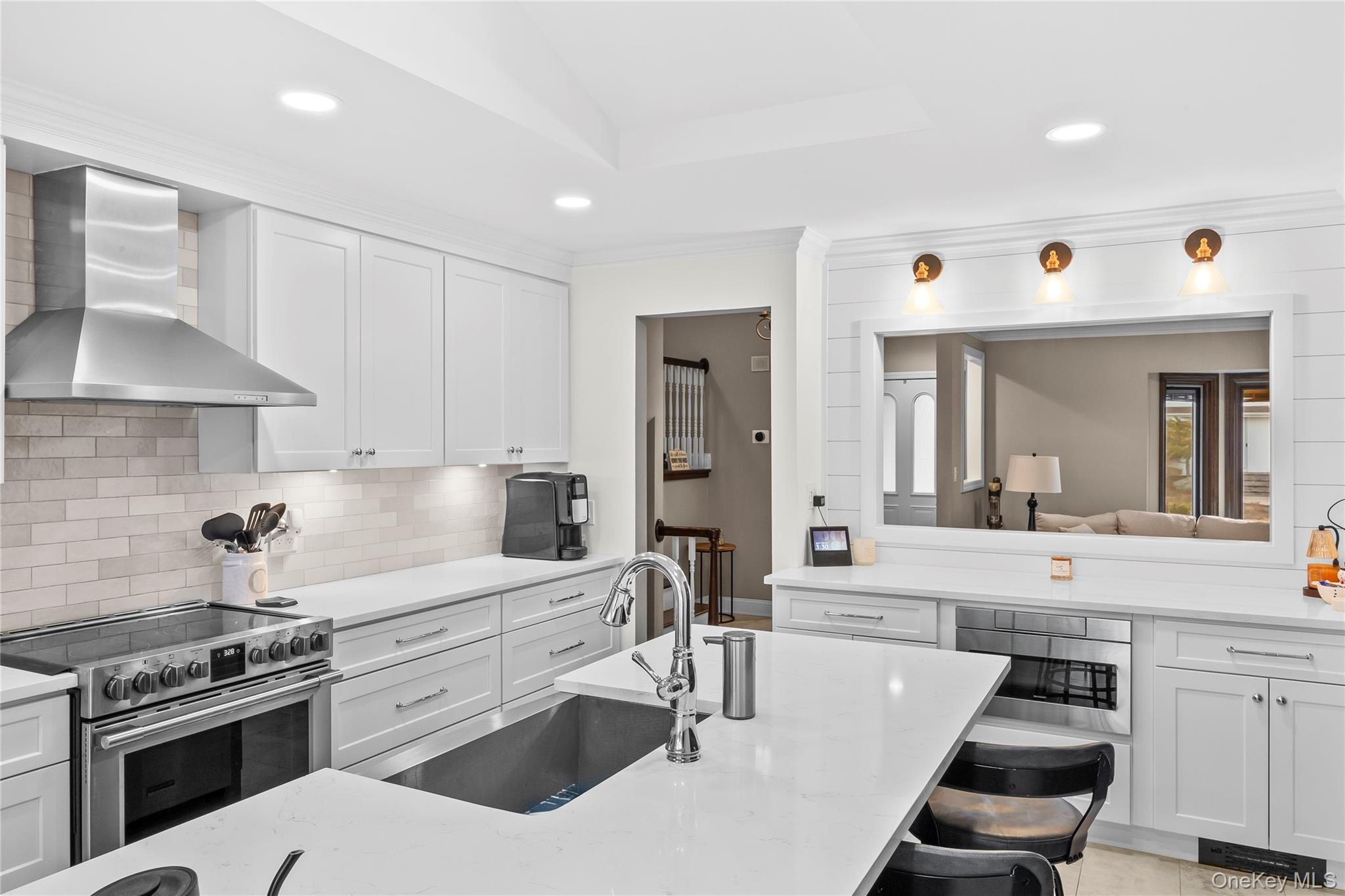 26 Glenwood Road Plainview, NY 11803 - Photo 13 of 42 a kitchen with stainless steel appliances kitchen island granite countertop a sink and cabinets