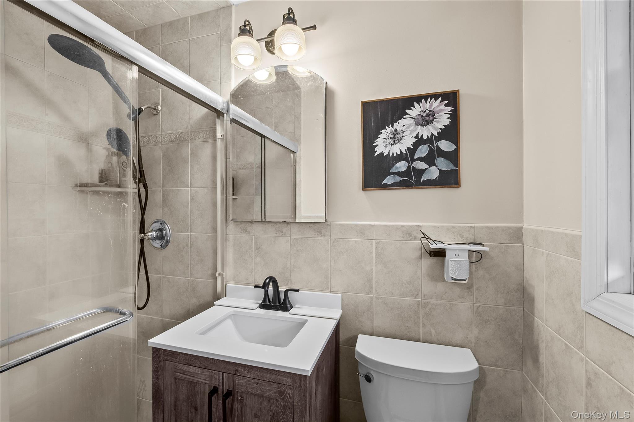 26 Glenwood Road Plainview, NY 11803 - Photo 16 of 42 a bathroom with a sink a toilet and shower