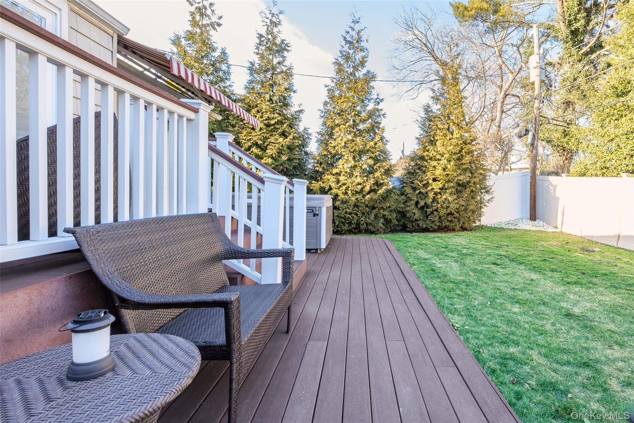 26 Glenwood Road Plainview, NY 11803 - Photo 32 of 42 a balcony with wooden floor table and chairs