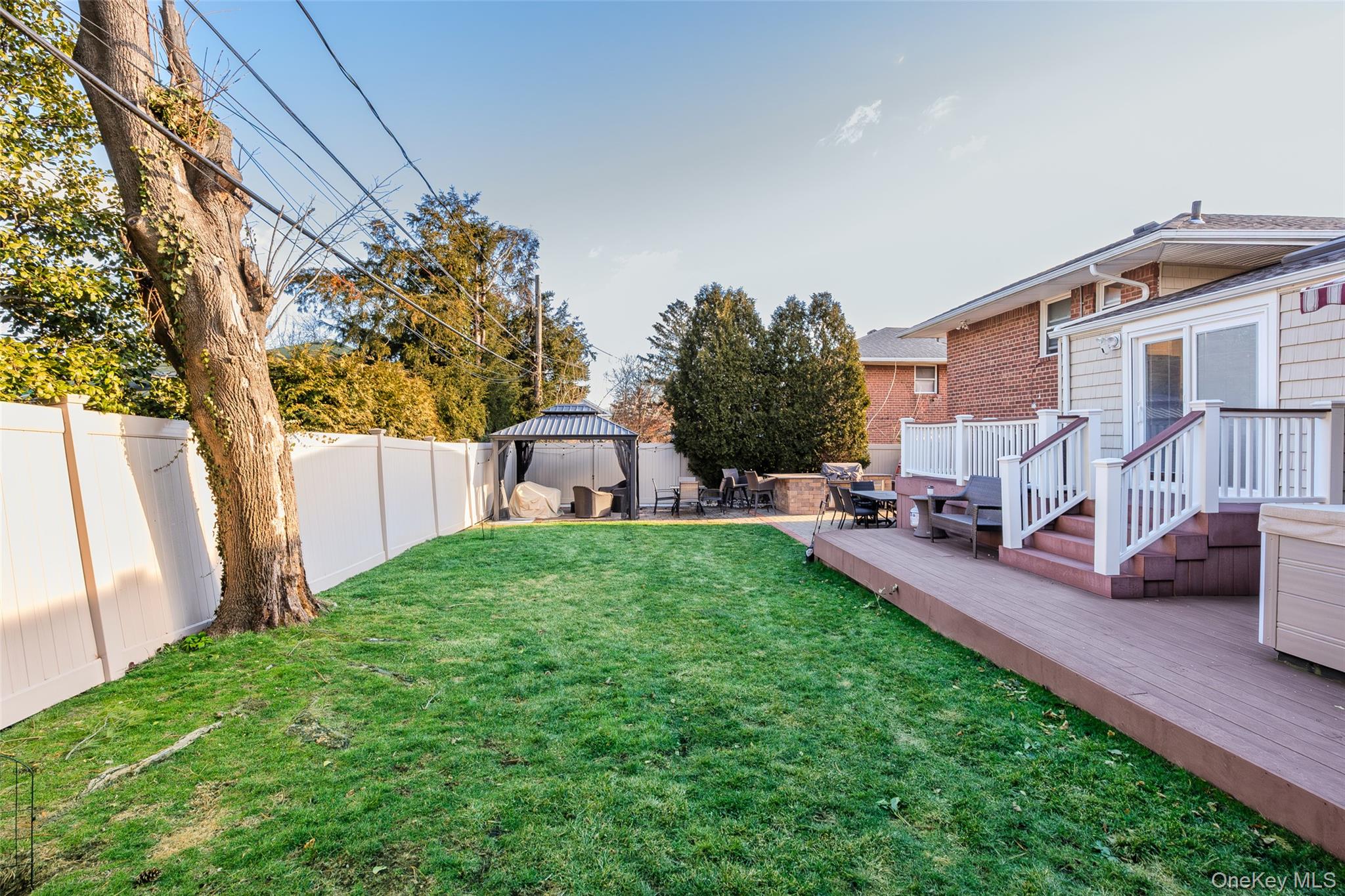 26 Glenwood Road Plainview, NY 11803 - Photo 37 of 42 a view of a backyard with furniture