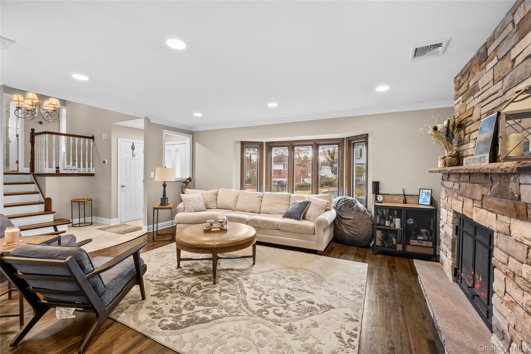 26 Glenwood Road Plainview, NY 11803 - Photo 7 of 42 a living room with fireplace furniture and a rug