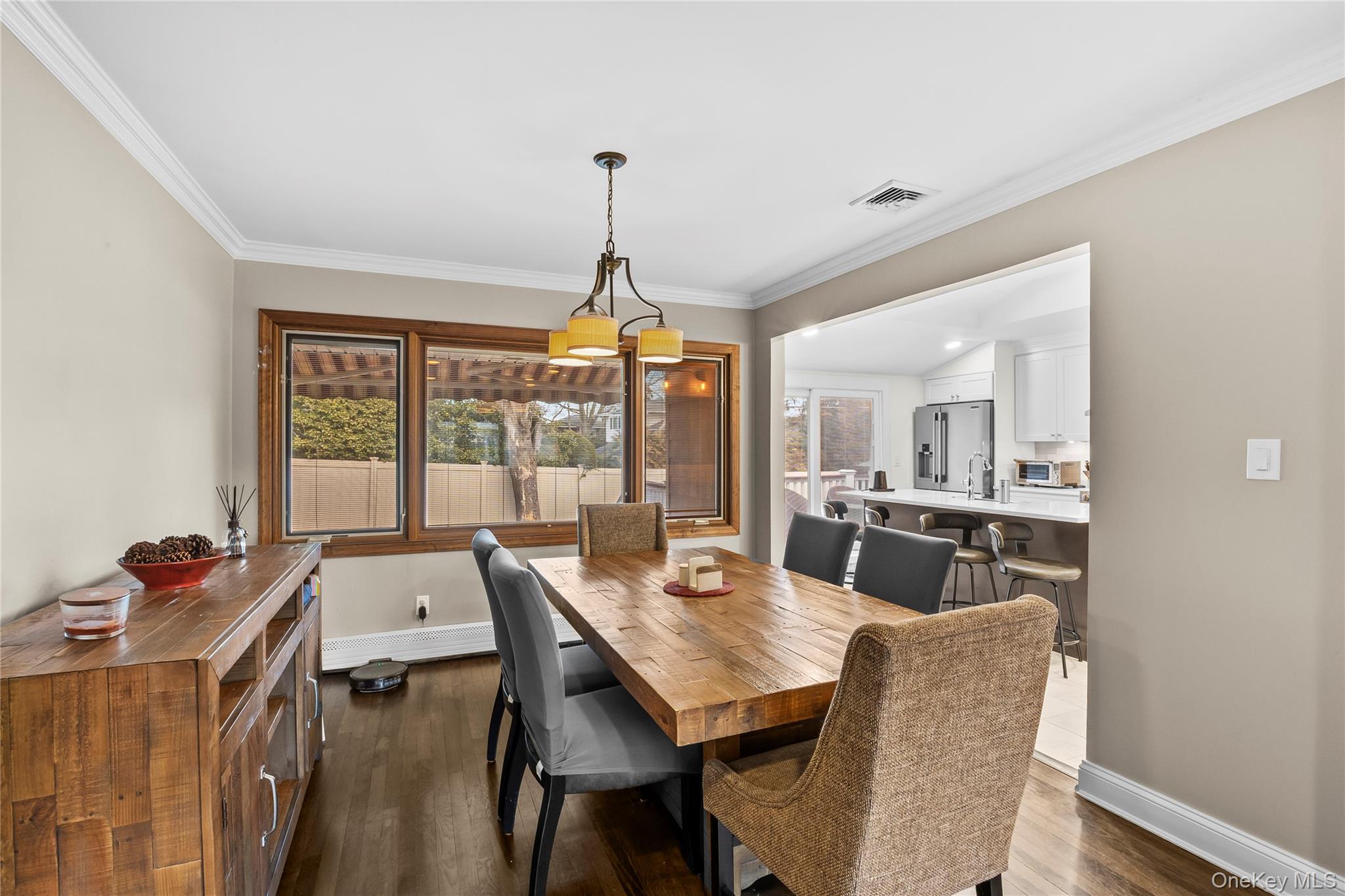 26 Glenwood Road Plainview, NY 11803 - Photo 9 of 42 a view of a dining room with furniture wooden floor and chandelier
