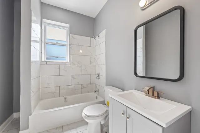 a bathroom with a sink a toilet and bathtub