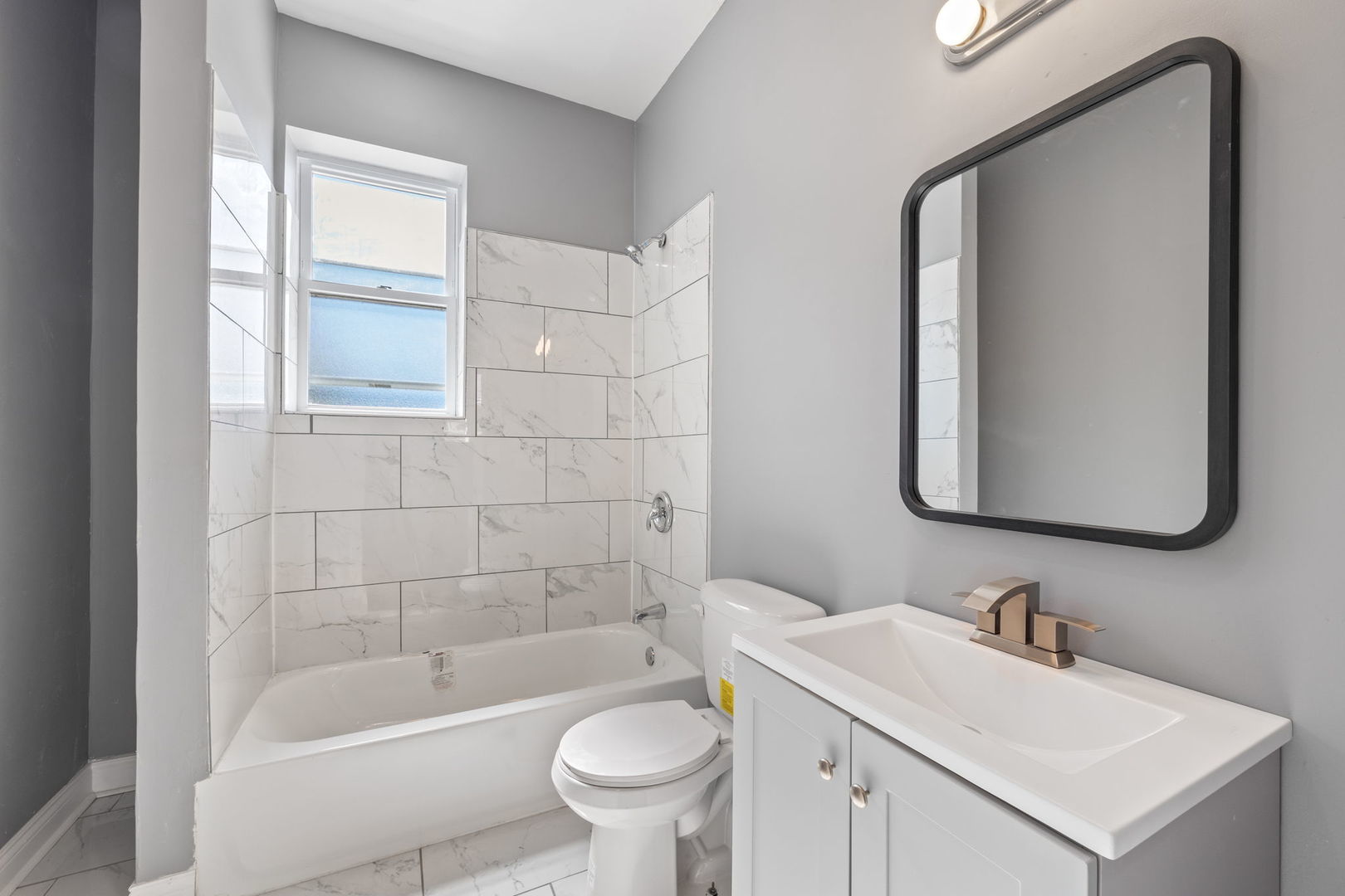 2408 South Trumbull Avenue Chicago, IL 60623 - Photo 12 of 34 a bathroom with a sink a toilet and bathtub