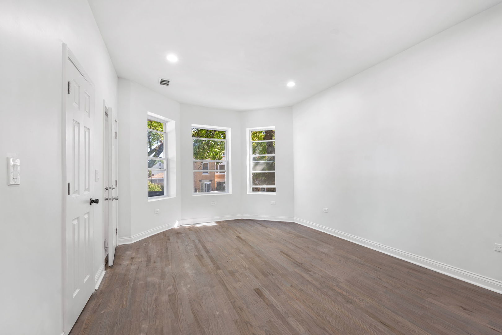2408 South Trumbull Avenue Chicago, IL 60623 - Photo 13 of 34 wooden floor in an empty room with a window