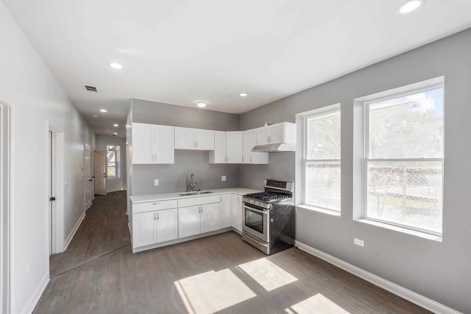 2408 South Trumbull Avenue Chicago, IL 60623 - Photo 14 of 34 a kitchen with stainless steel appliances a sink a stove a refrigerator cabinets and a window