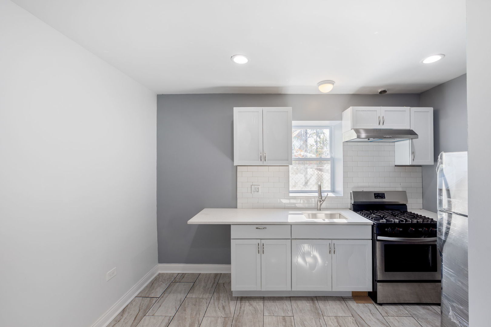 2408 South Trumbull Avenue Chicago, IL 60623 - Photo 23 of 34 a kitchen with a sink stove and cabinets