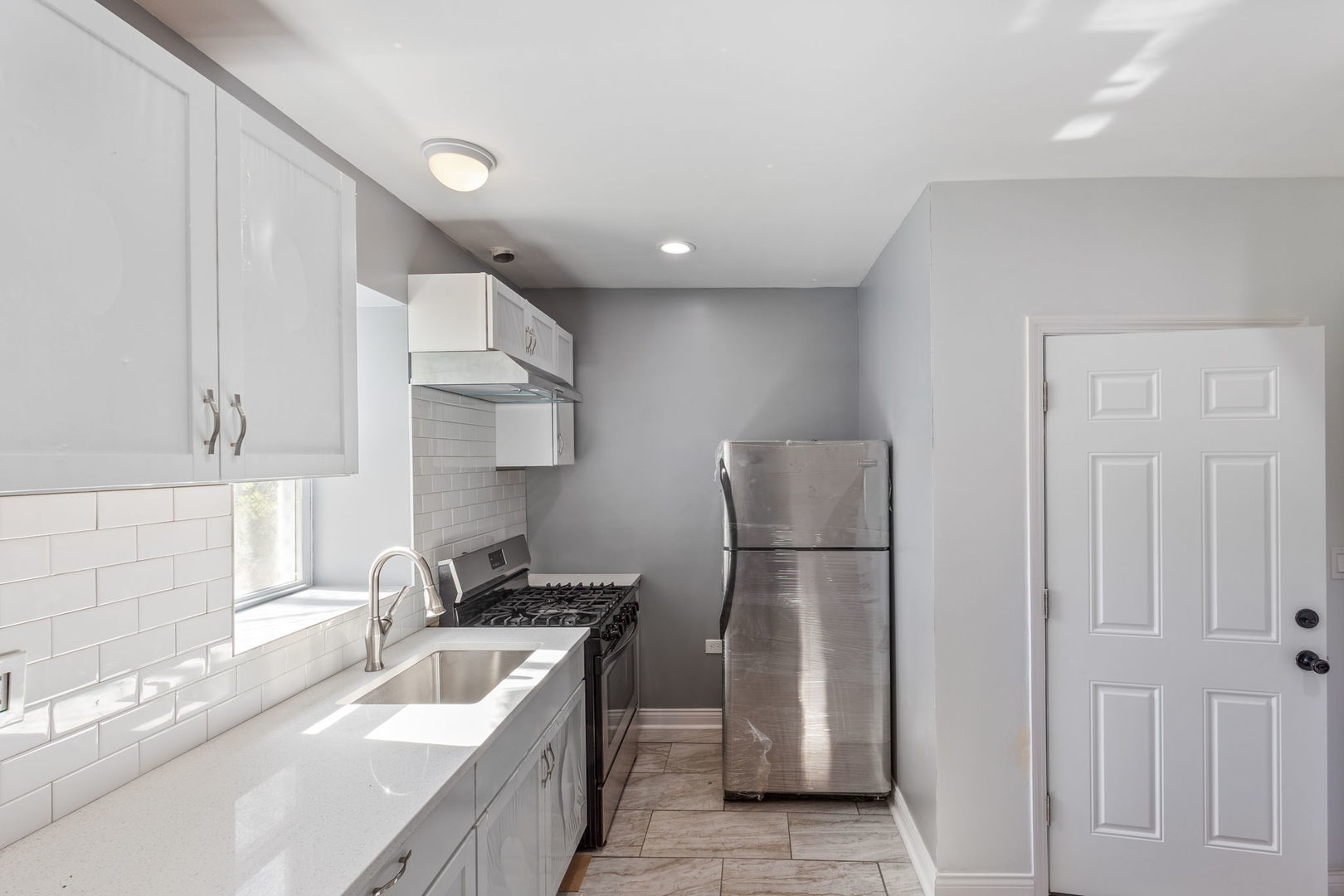 2408 South Trumbull Avenue Chicago, IL 60623 - Photo 24 of 34 a kitchen with stainless steel appliances granite countertop a sink stove and refrigerator