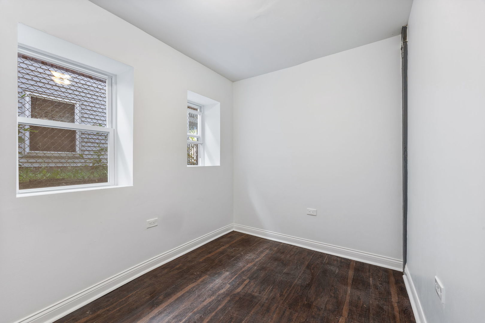 2408 South Trumbull Avenue Chicago, IL 60623 - Photo 26 of 34 a view of an empty room with wooden floor and a window