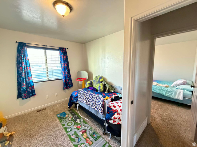 2095 West 4100 North Spring Glen, UT 84526 - Photo 11 of 35 Carpeted bedroom featuring baseboards