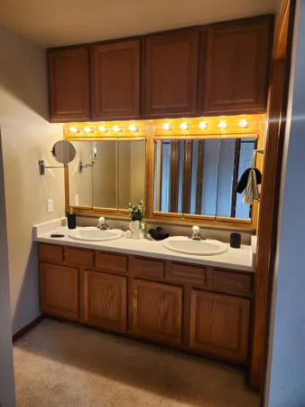 a bathroom with a double vanity sink and a large mirror