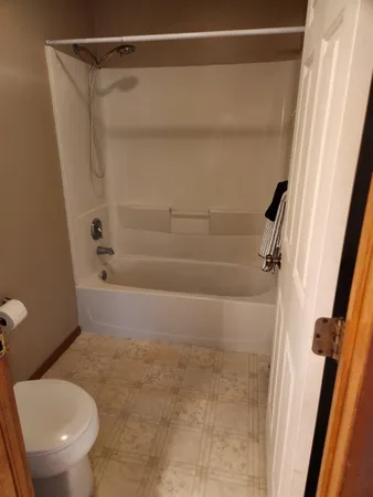 a bathroom with a toilet and a shower