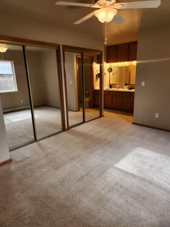 a view of an empty room with a kitchen