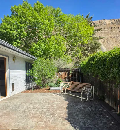 a view of backyard with deck and outdoor seating
