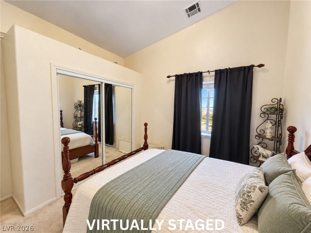 5470 Grain Mill Road Pahrump, NV 89061 - Photo 43 of 80 VIRTUALLY STAGED High vaulted ceilings and mirrored sliding doors highlight this comfortable bedroom space.