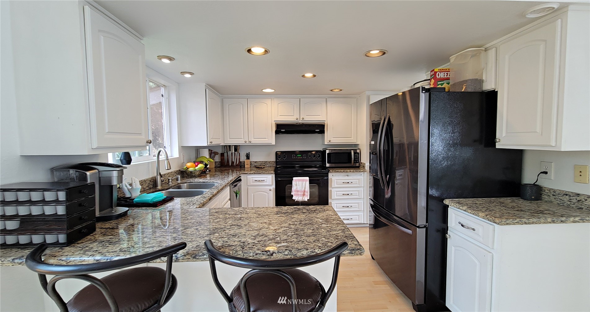 2652 Southwest 333rd Place Federal Way, WA 98023 - Photo 18 of 40 a kitchen with stainless steel appliances granite countertop a refrigerator a stove a sink a dining table and chairs