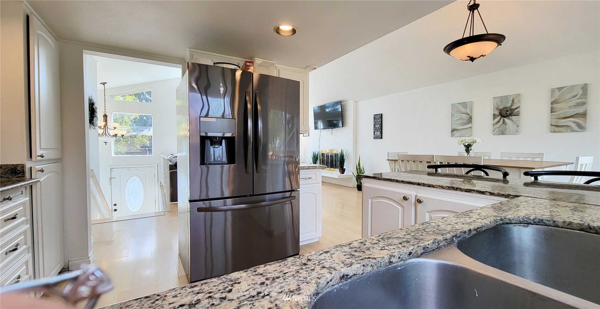 2652 Southwest 333rd Place Federal Way, WA 98023 - Photo 19 of 40 a kitchen with stainless steel appliances granite countertop a refrigerator a stove and a sink with wooden floor