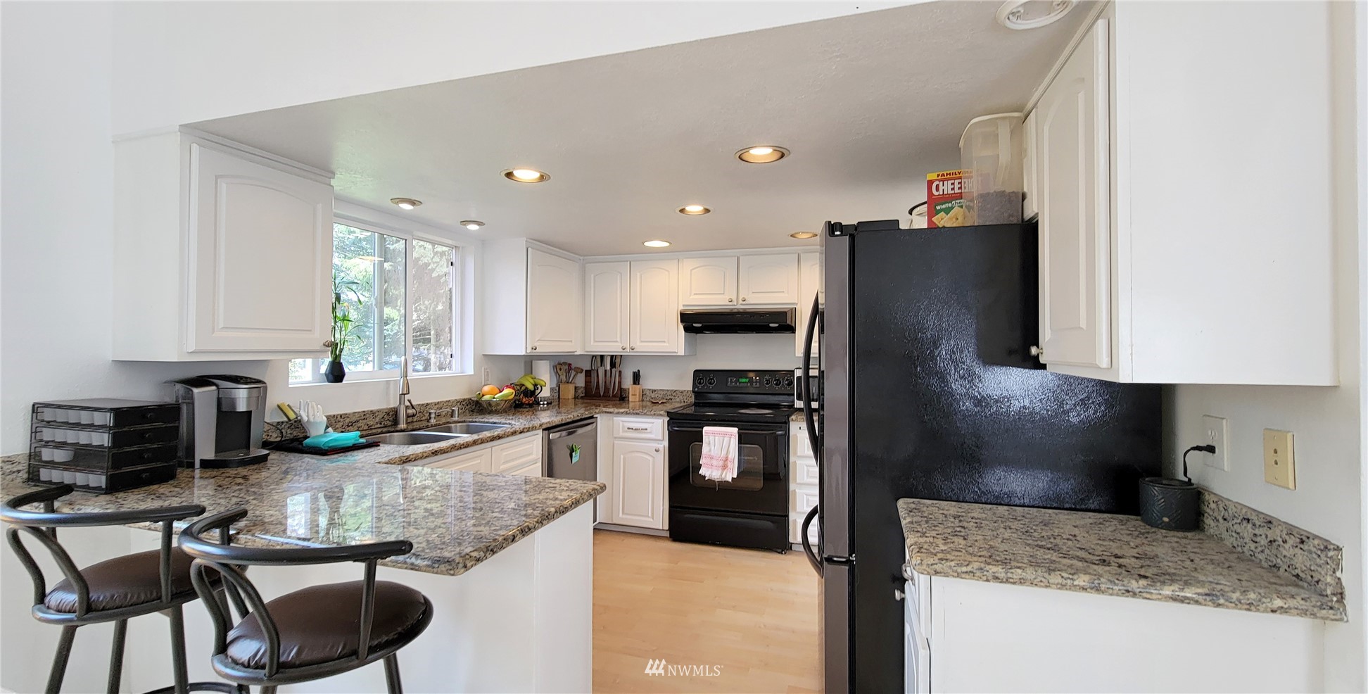 2652 Southwest 333rd Place Federal Way, WA 98023 - Photo 20 of 40 a kitchen with granite countertop kitchen island stainless steel appliances a refrigerator stove a sink and a dining table