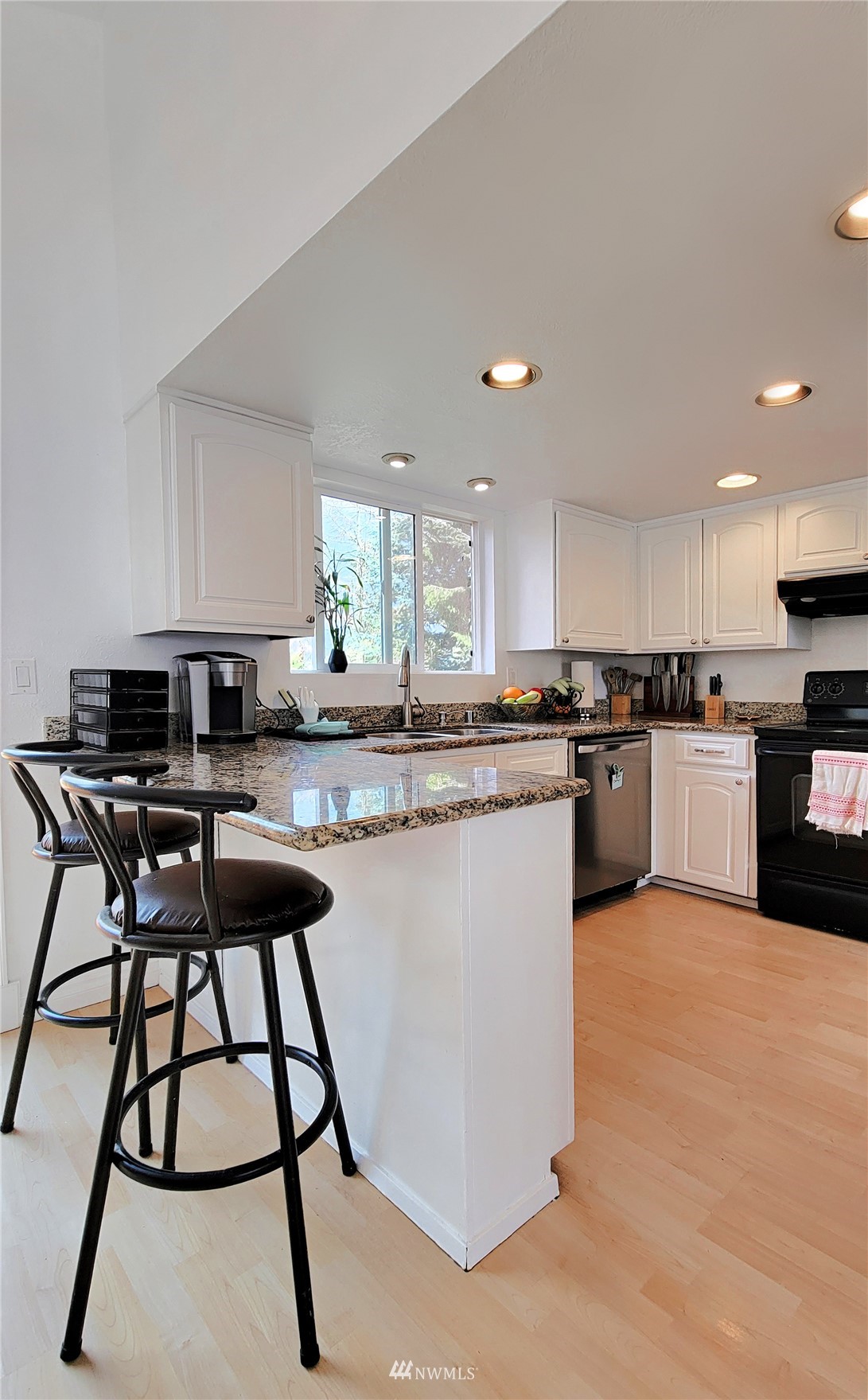 2652 Southwest 333rd Place Federal Way, WA 98023 - Photo 21 of 40 a kitchen with stainless steel appliances kitchen island granite countertop a stove top oven a sink a dining table and chairs