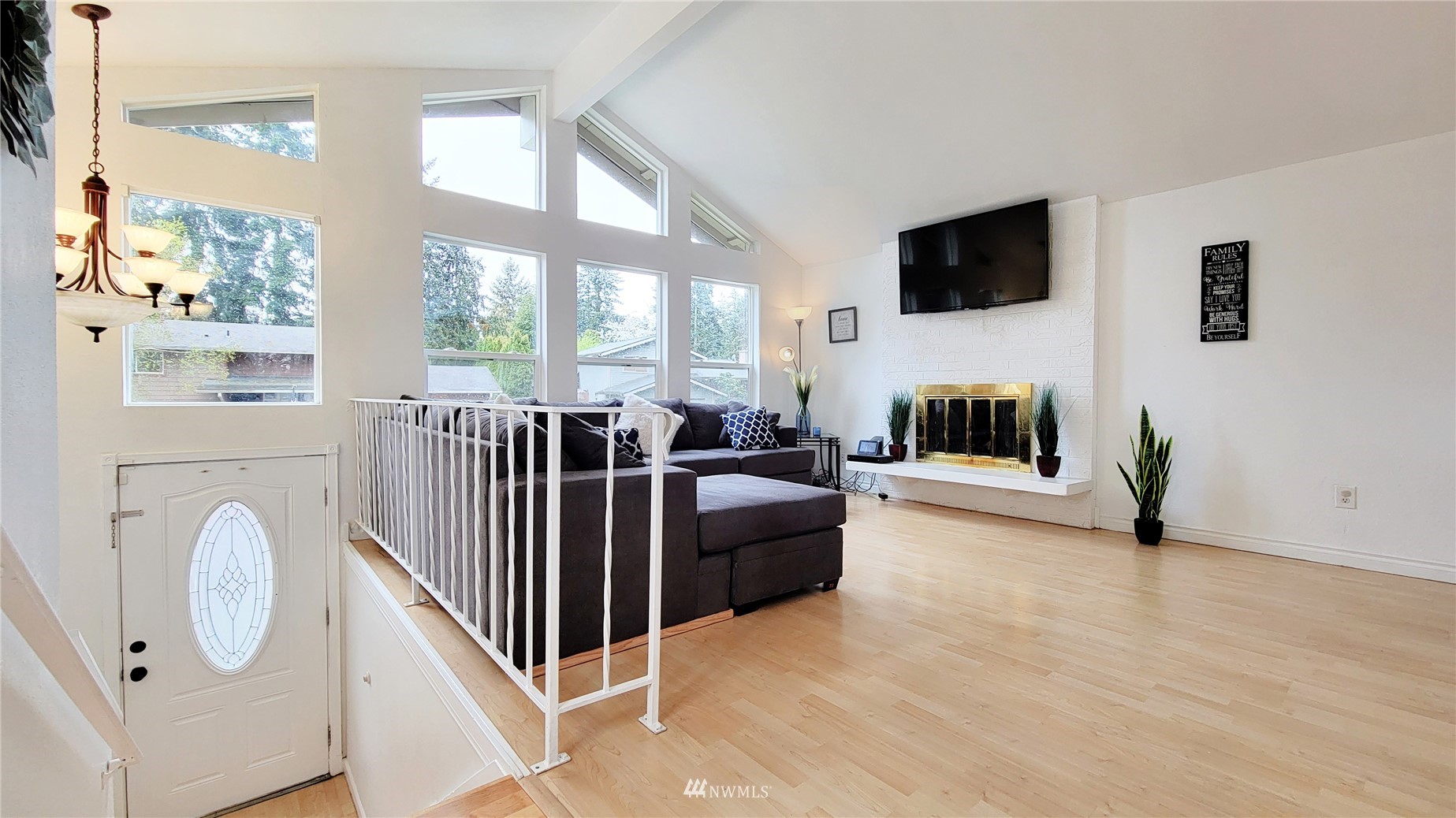 2652 Southwest 333rd Place Federal Way, WA 98023 - Photo 7 of 40 a living room with furniture a flat screen tv and a fireplace