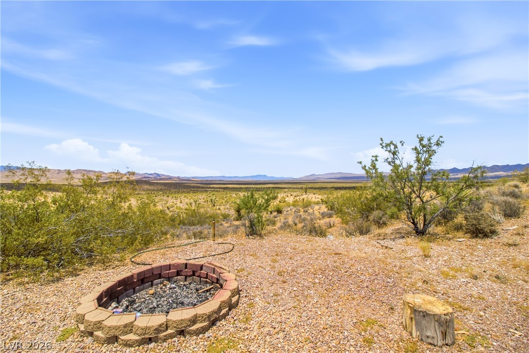 Rocking S Ranch Road Searchlight, NV 89046 - Photo 12 of 47 A desert oasis with a fire pit invites relaxation amidst sprawling natural beauty.