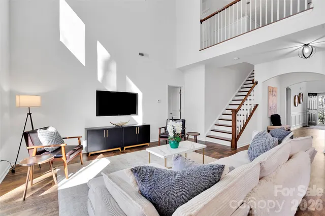 a living room with furniture and wooden floor