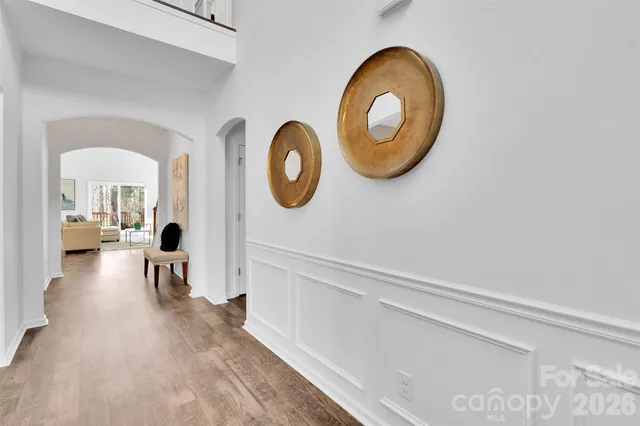 a bedroom with a bed a mirror and a large window