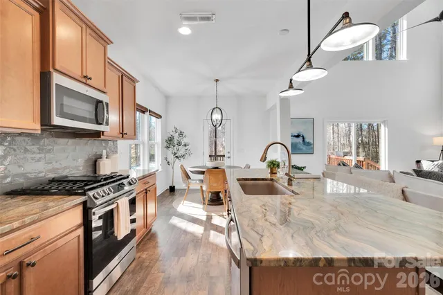 a kitchen with stainless steel appliances granite countertop a stove and a sink