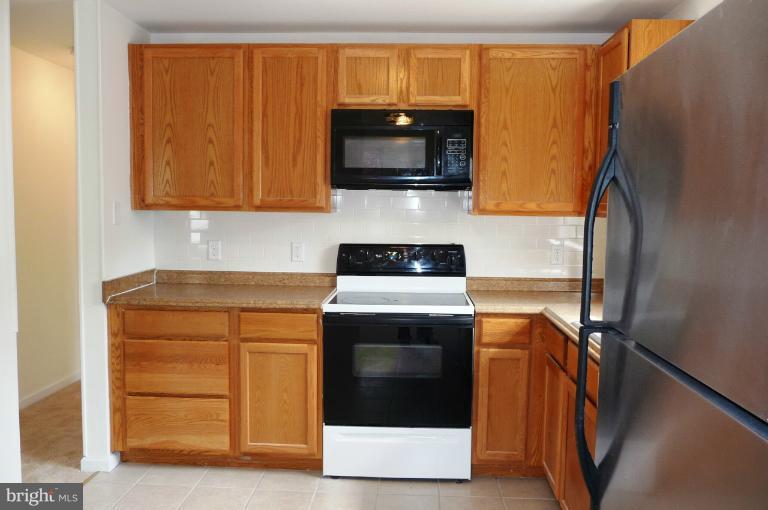 117 Spring Street Gaithersburg, MD 20877 - Photo 3 of 23 a kitchen with a stove and a microwave