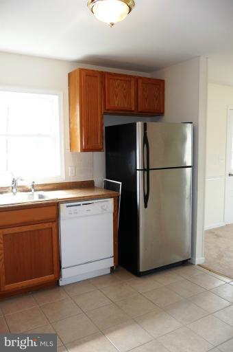 117 Spring Street Gaithersburg, MD 20877 - Photo 7 of 23 a kitchen with stainless steel appliances granite countertop a refrigerator a sink and a more cabinets