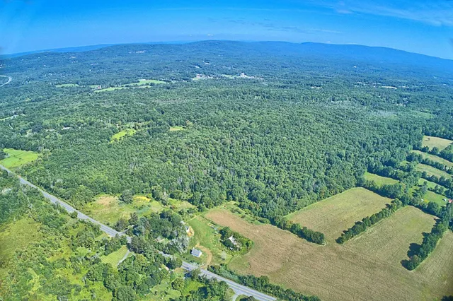 a kitchen with a table chairs refrigerator and microwave