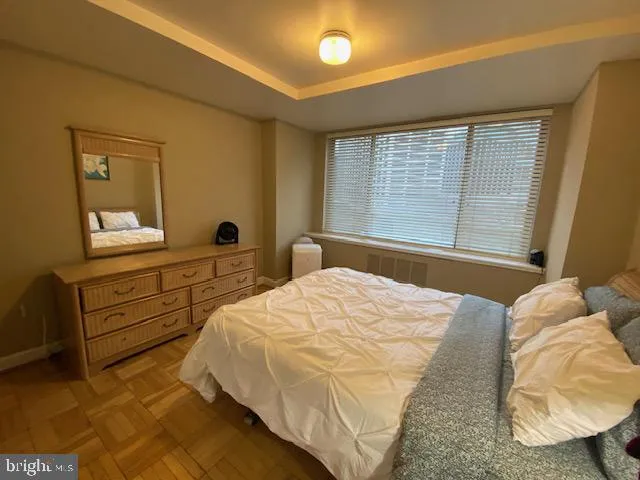 a bedroom with a bed and a dresser