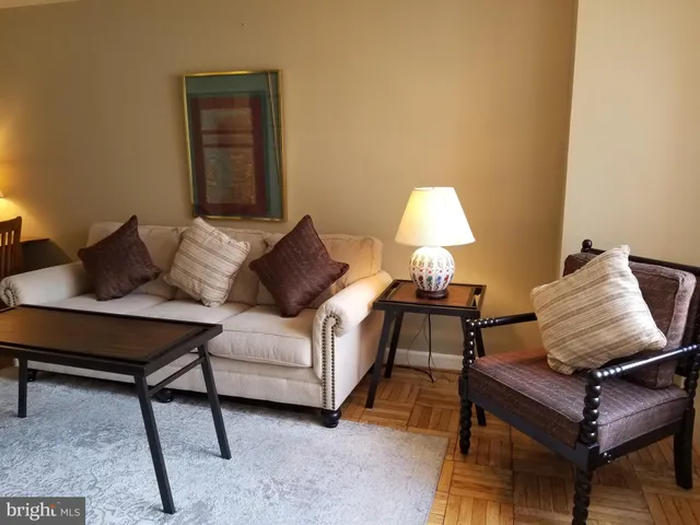 a living room with furniture and a lamp