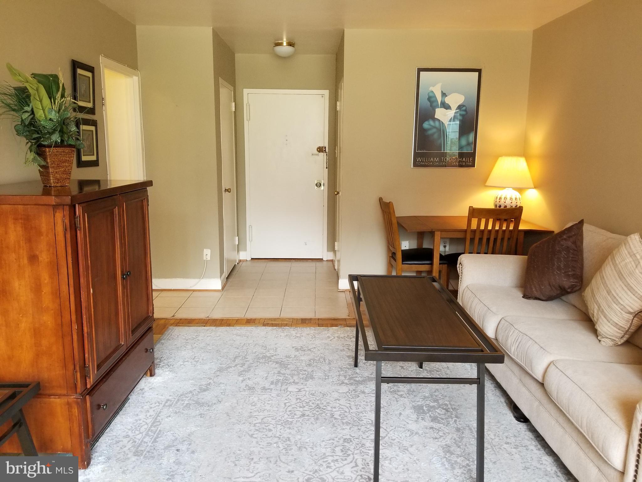 1121 Arlington Boulevard, Unit 620 Arlington, VA 22209 - Photo 7 of 33 a living room with furniture and a table