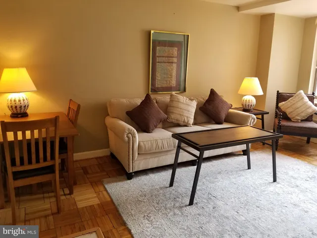 a living room with furniture and a lamp