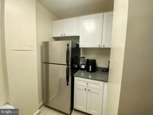 a white refrigerator freezer sitting inside of a kitchen