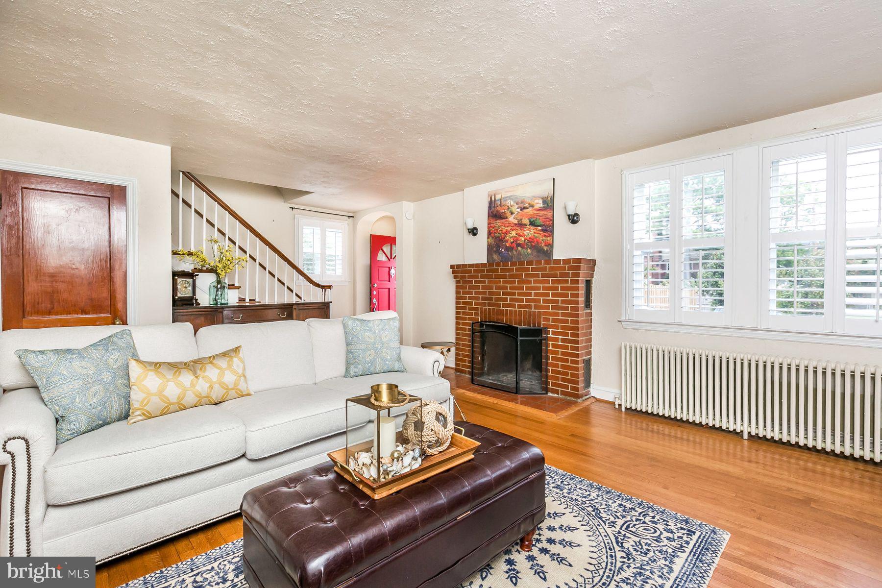 816 Warwick Road Baltimore, MD 21229 - Photo 10 of 44 Family room with fireplace & hardwood floors