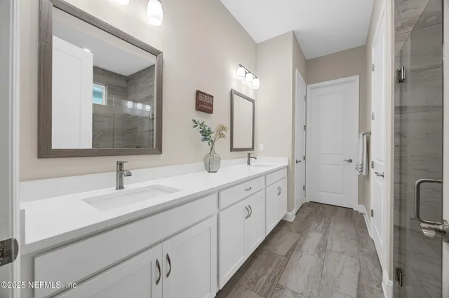 a bathroom with a double vanity sink and mirror