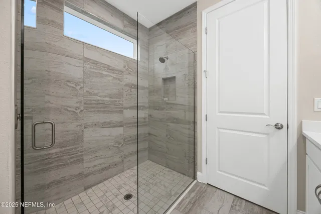 a bathroom with a glass shower door
