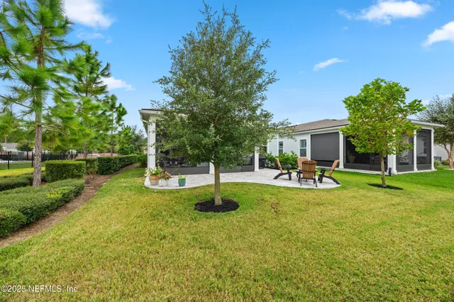 a view of a house with swimming pool and sitting area