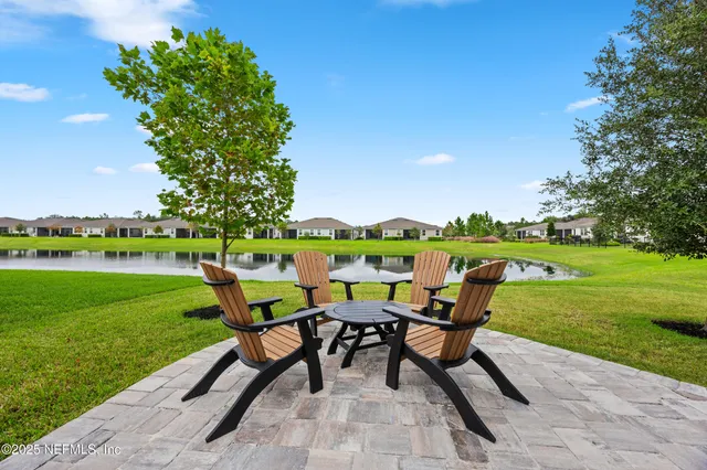 a view of a yard with furniture and garden
