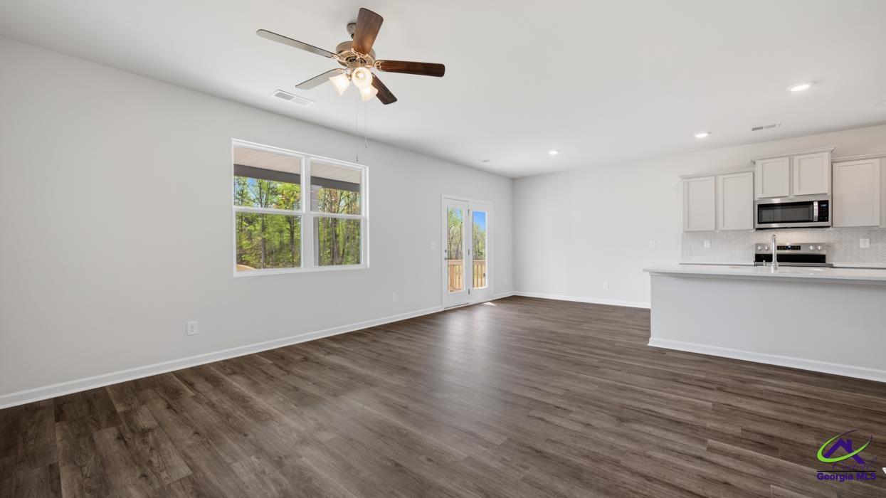 227 Cattle Drive Perry, GA 31069 - Photo 27 of 40 a view of an empty room with window and wooden floor
