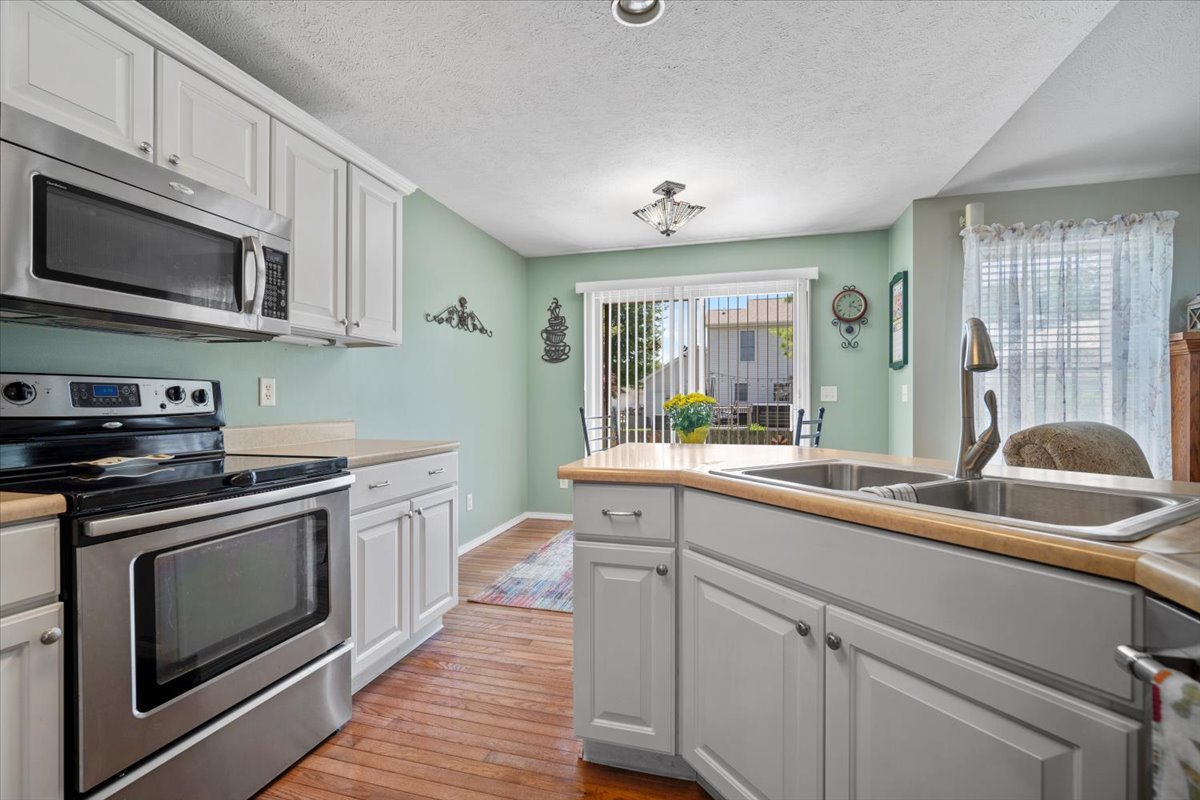 3205 Stonebridge Drive Bloomington, IL 61704 - Photo 12 of 37 a kitchen with stainless steel appliances granite countertop a sink and a stove