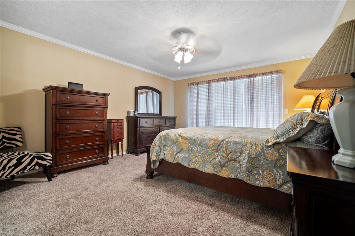 3205 Stonebridge Drive Bloomington, IL 61704 - Photo 13 of 37 a bed sitting in a bedroom next to a window and dresser