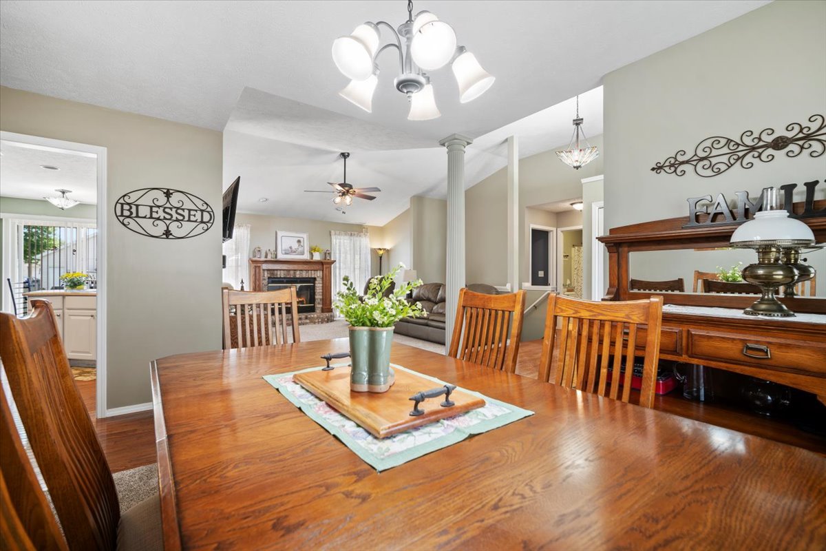 3205 Stonebridge Drive Bloomington, IL 61704 - Photo 19 of 37 a living room with kitchen island furniture and a chandelier