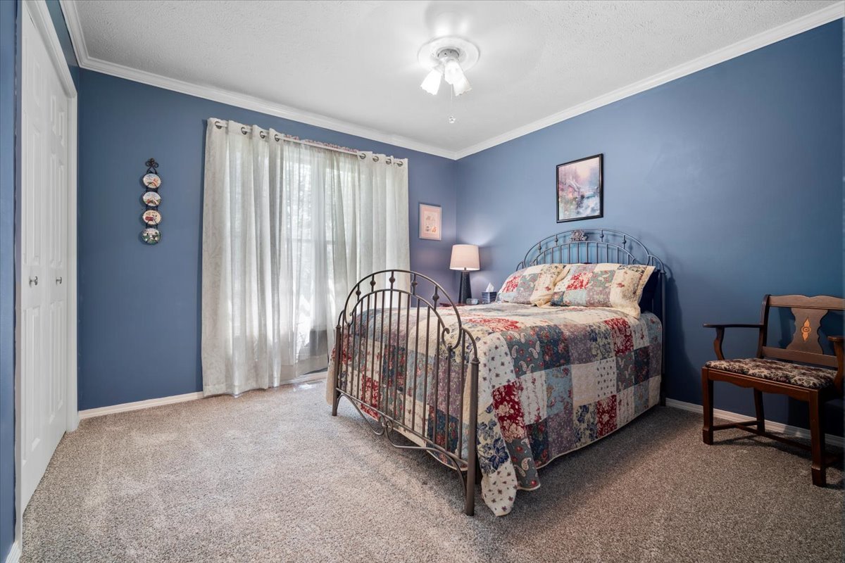 3205 Stonebridge Drive Bloomington, IL 61704 - Photo 20 of 37 a bed sitting in a spacious bedroom next to a window