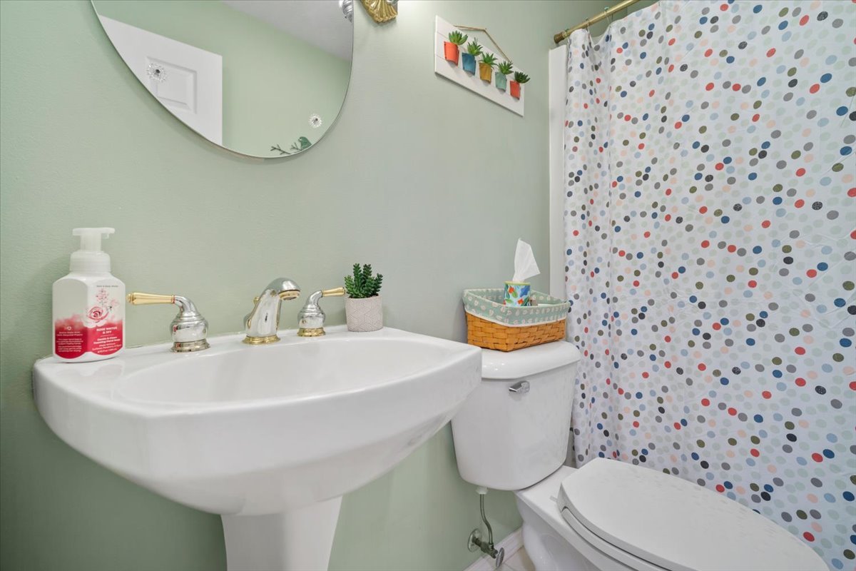 3205 Stonebridge Drive Bloomington, IL 61704 - Photo 21 of 37 a bathroom with a sink a toilet and a mirror
