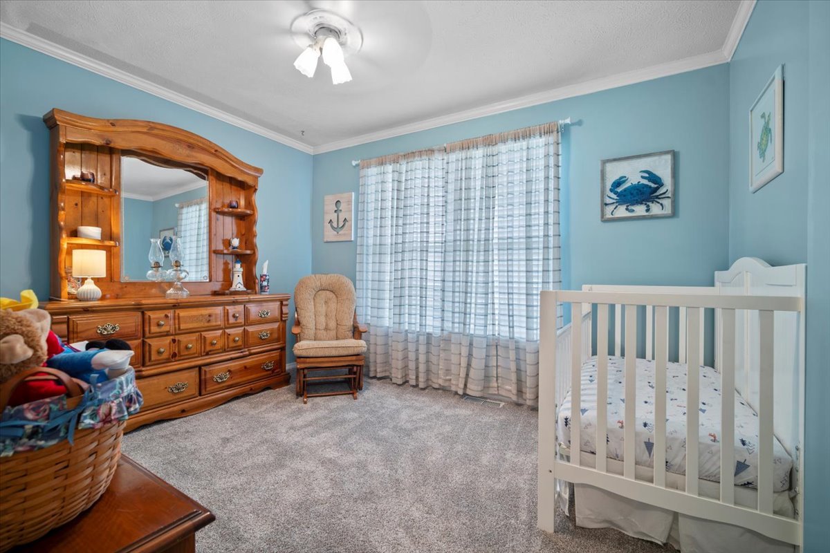 3205 Stonebridge Drive Bloomington, IL 61704 - Photo 22 of 37 a bedroom with furniture and a window